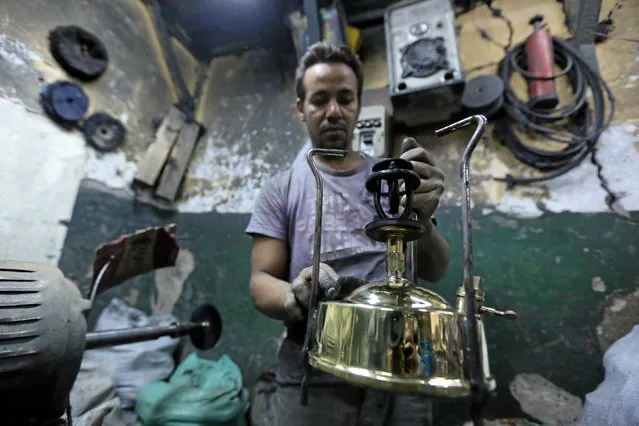 A worker manufacturing primus stoves known as “Bagour” in Arabic, in Cairo, Egypt, May 11, 2016. (Photo by Mohamed Abd El Ghany/Reuters)
