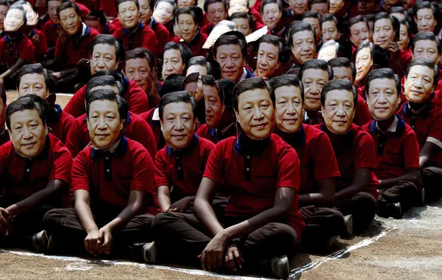 Indian school children wear face masks of Chinese President Xi Jinping to welcome him on the eve of his visit in Chennai, India, Thursday, October 10, 2019. Chinese President Xi Jinping is coming to India to meet with Prime Minister Narendra Modi on Friday, just weeks after Beijing supported India's rival Pakistan in raising the issue of New Delhi's recent actions in disputed Kashmir at the U.N. General Assembly meeting. (Photo by R. Parthibhan/AP Photo)