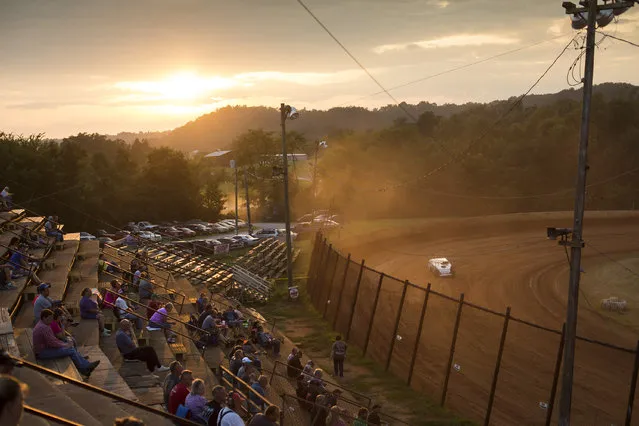 In this July 17, 2015 photo, cars race on a dirt track at the Ponderosa Speedway in Junction City, Ky. The Speedway, in operation since 1972, is among a handful of dirt racetracks sprinkled across Kentucky where weekend drivers, their crews and families can test their mechanical and driving skills. (Photo by David Stephenson/AP Photo)