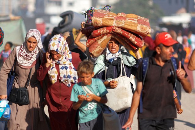 Displaced Palestinians make their way as they flee the eastern part of Khan Younis following an Israeli army evacuation order, amid the Israel-Hamas conflict, in Khan Younis in the southern Gaza Strip on August 8, 2024. (Photo by Mohammed Salem/Reuters)