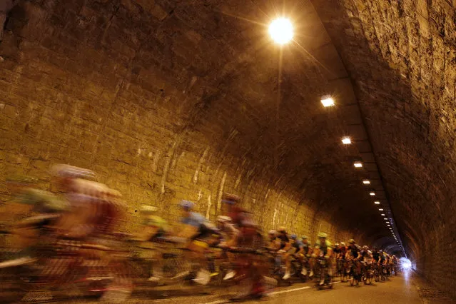 The pack passes through a tunnel during the ninth stage of the Tour de France cycling race over 181.5 kilometers (112.8 miles) with start in Nantua and finish in Chambery, France, Sunday, July 9, 2017. Mori's injury forced him to abandon the race. (Photo by Christophe Ena/AP Photo)