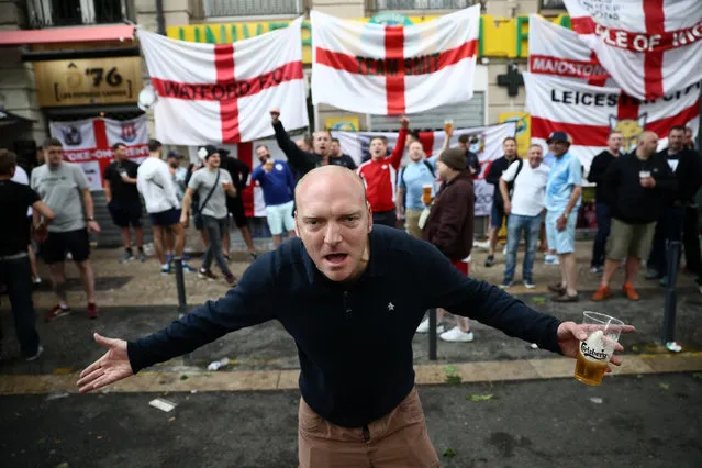 An England fan gestures as he drinks with other fans ahead of tomorrow's England v Slovakia Euro 2016 Group B match, on June 19, 2016 in Saint-Etienne, France. Following a draw against Russia in Marseille and a win against Wales in Lille, England fans have travelled to the central French city for the final group game against Slovakia. (Photo by Carl Court/Getty Images)