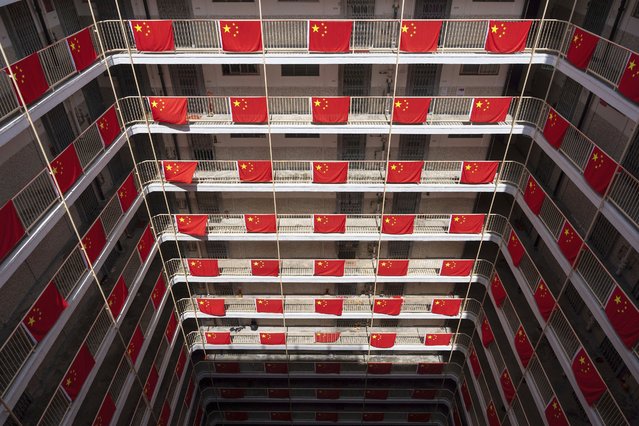 Flags of China are hung in a residential building to mark the 75th National Day of the People's Republic of China in Hong Kong, Tuesday, October 1, 2024. (Photo by Chan Long Hei/AP Photo)