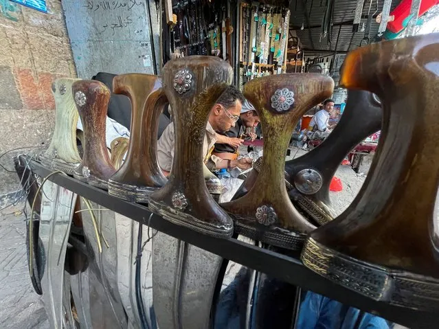 Craftsmen work on traditional daggers, known as Jambiya, outside a shop in Sanaa, Yemen on May 23, 2022. (Photo by Khaled Abdullah/Reuters)
