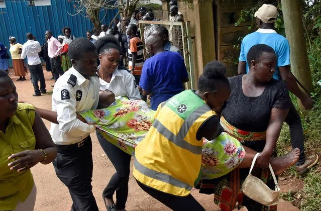 Medical staff assist a parent after she identified the body of her child killed in a stampede at the Kakamega Primary School, at the Kakamega County General Teaching & Referral Hospital in Kakamega, Kenya on February 4, 2020. (Photo by James Keyi/Reuters)
