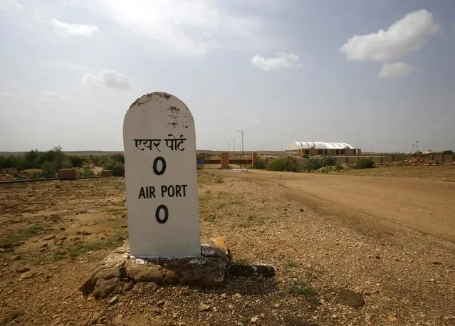 A milestone is seen outside the Jaisalmer Airport in desert state of Rajasthan, India, August 13, 2015. (Photo by Anindito Mukherjee/Reuters)