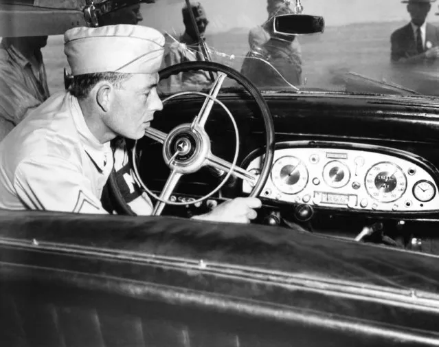 An unidentified MP inspects the dashboard of Reichsmarshall Hermann Goering's personal automobile, unloaded from the S. S. George Shiras at Boston on August 8, 1945. The Mercedes-Benz, a powerful 8400-pound job with bullet proof glass an inch and a half thick in its windows and an overall body covering of 2-inch armor steel, is consigned to Camp Cooke, California. Bullet holes in windshield. (Photo by AP Photo)