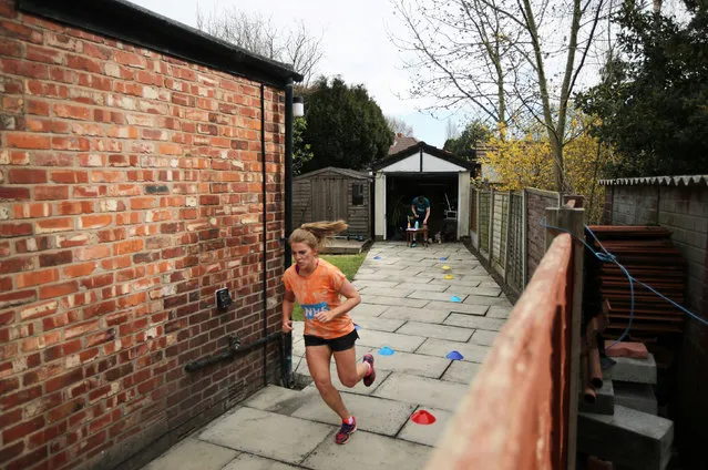 Cloda Lowden runs a marathon in her garden raising money for NHS, as the spread of the coronavirus disease (COVID-19) continues, Manchester, Britain, April 5, 2020. (Photo by Molly Darlington/Reuters)