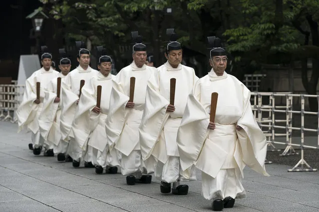 Priests walk through Yasukuni Shrine during the annual spring rites on April 21, 2020 in Tokyo, Japan. The shrine's annual rites are held through April 22 amid the state of emergency to cover the entire country as COVID-19 coronavirus infections continue to spread. The shrine honors Japan's war dead during the period from 1867 to the end of the war, including 14 Class A war criminals. (Photo by Tomohiro Ohsumi/Getty Images)