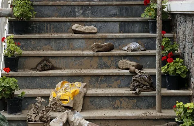 Shoes left on the steps of a villa at the site of a flash flood in Zayegan village, in city of Fasham, northern of the capital city of Tehran, Iran, 02 August 2022. According to the last report by Iranian Red Crescent Society quoting local officials, at least 76 people were killed and 16 others are missing in recent floods in most cities of Iran. (Photo by Abedin Taherkenareh/EPA/EFE/Rex Features/Shutterstock)