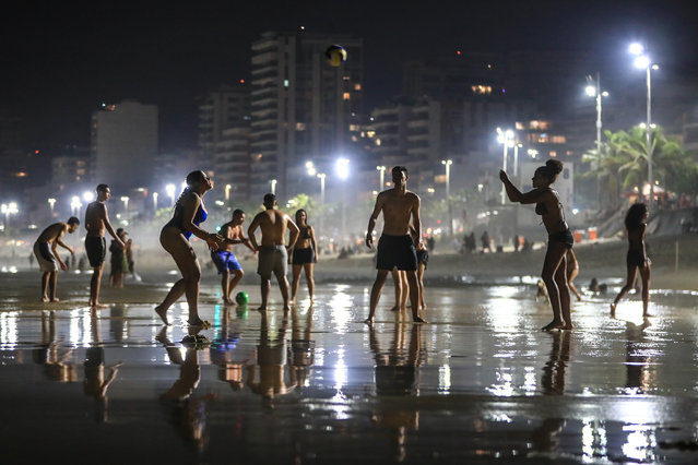 People gather at the shore of Arpoador beach in Rio de Janeiro, Brazil, 16 November 2023. Rio had the hottest day of the year on 16 November, with a maximum temperature, 40.6ºC, recorded at the Marambaia station, according to the National Institute of Meteorology (Inmet). (Photo by André Coelho/EPA/EFE)