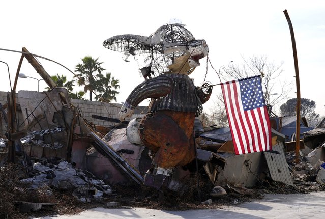 An American flag is suspended from a charred bunny sculpture at the Bunny Museum, which was destroyed by the Eaton Fire in January, Monday, February 17, 2025, in Altadena, Calif. (Photo by Chris Pizzello/AP Photo)