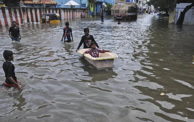 A boy pushes another in a bathtub in a waterlogged street in Chennai, India, Friday, November 3, 2017. Incessant rainfall caused waterlogging and traffic jams in several parts of the southern Indian city on Friday. (Photo by AP Photo/Stringer)