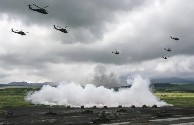 Japan Ground Self-Defense Force (JGSDF)'s tanks and helicopters participate in a fire drill at Higashi Fuji training field in Gotenba, central Japan, 25 August 2016. About 2,400 JGSDF personnel with some 80 tanks and armored vehicles participated in the drill, taking place also on 27 and 28 August. (Photo by Kimimasa Mayama/EPA)