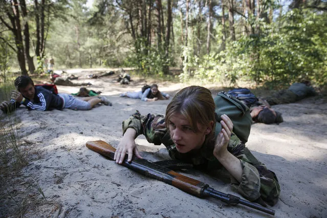 Ukrainians in military uniforms take up positions as they attend a military training session organized for civilians, in Kiev, Ukraine, 21 June 2015. The European Union on 19 June extended economic sanctions imposed on the Ukrainian peninsula of Crimea and the city of Sevastopol following their annexation by Russia, with the measures now due to stay in place until 23 June  2016. The sanctions were introduced last year, to reinforce the EU's opposition to Russia's illegal annexation of the two territories in March 2014. Relations between Brussels and Moscow are at their worst level since the end of the Cold War, due to Russia's actions in Crimea and in eastern Ukraine, where it is accused of supporting pro-Russian separatists. (Photo by Roman Pilipey/EPA)