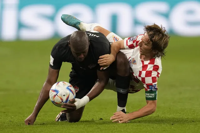 Croatia's Luka Modric fights for the ball with Canada's Kamal Miller during the World Cup group F soccer match between Croatia and Canada, at the Khalifa International Stadium in Doha, Qatar, Sunday, November 27, 2022. (Photo by Darko Vojinovic/AP Photo)