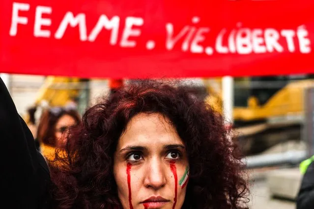 A protestor with red tears painted on her face during a rally in support of the demonstrations in Iran, in Toulouse, south-western France, on December 3, 2022. (Photo by Charly Triballeau/AFP Photo)