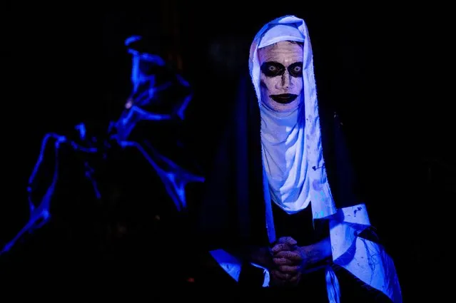 A boy dressed as Valak for Halloween poses for a photo, at a horror house in Manila, Philippines on October 31, 2022. (Photo by Lisa Marie David/Reuters)