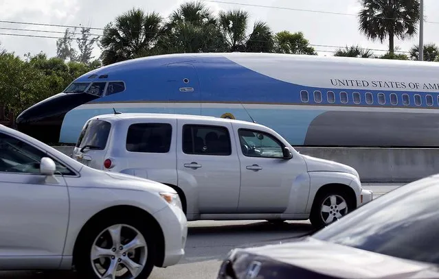 A replica of Air Force One travels on a flatbed truck eastbound on Southern Blvd. to the South Florida Fairgrounds in West Palm Beach, January 9, 2013. The 65-foot by 12-foot fuselage replicates the Air Force One that was used for nearly three decades, from President John F. Kennedy through President Ronald Reagan. The South Florida Fair's Exposition Hall will take on a presidential look later in the month. A number of new attractions will be set up in the 70,000 square foot expo space with the theme, “Washington, D.C., Our Nation's Capital”. (Photo by Allen Eyestone/The Palm Beach Post)