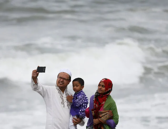 A Muslim family takes a selfie picture in front of the sea after the morning prayer to celebrate Eid al-Adha in Colombo, Sri Lanka September 12, 2016. (Photo by Dinuka Liyanawatte/Reuters)