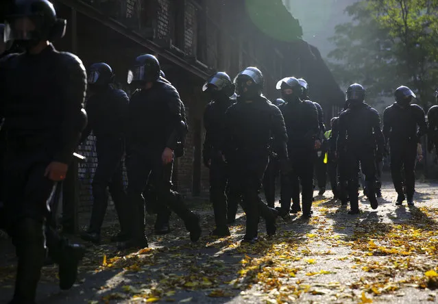 Police officer walk to detain demonstrators during an opposition rally to protest the official presidential election results in Minsk, Belarus, Saturday, September 26, 2020. (Photo by TUT.by via AP Photo)
