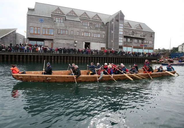 Crew in Britain's first ever full-size reconstructed sea-going Bronze Age boat, paddle out to sea near to the National Maritime Museum as it makes its maiden voyage on March 6, 2013 in Falmouth, England. Photo by Matt Cardy)