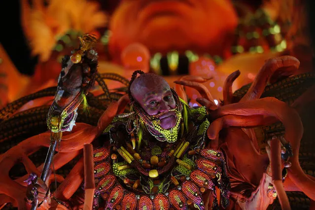 A performer from the Salgueiro samba school parades during Carnival celebrations at the Sambadrome in Rio de Janeiro, Brazil, early Tuesday, February 13, 2018. (Photo by Silvia Izquierdo/AP Photo)