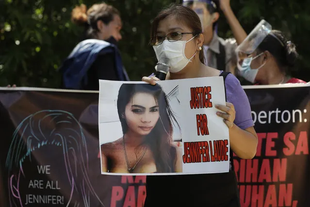 A protester holds a slogan with a photo of the killed transgender Filipino woman Jennifer Laude during a rally in Quezon city, Philippines, Friday, September 11, 2020. The Philippine president recently pardoned Pemberton in a surprise move that will free him from imprisonment in the 2014 killing of Laude that sparked anger in the former American colony. (Photo by Aaron Favila/AP Photo)