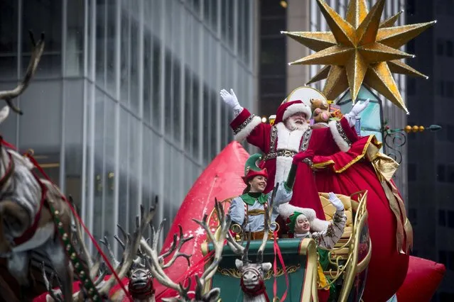 A man dressed as Santa Claus waves during the 88th Annual Macy's Thanksgiving Day Parade in New York November 27, 2014. (Photo by Andrew Kelly/Reuters)