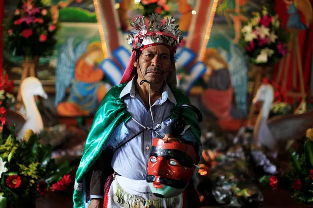 A participant in the traditional dance of Los Historiantes poses for a photo during festivities in honour of St. Michael the Archangel in San Miguel Tepezontes, El Salvador September 28, 2016. (Photo by Jose Cabezas/Reuters)