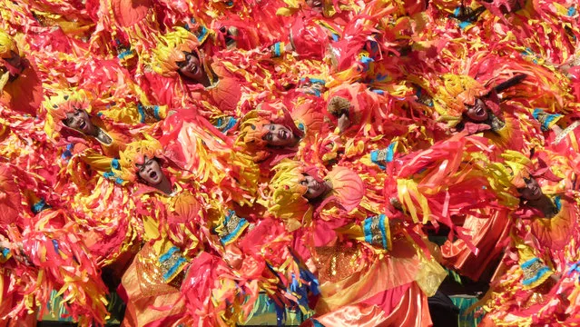 “The swirling dancers of Tribu Pangat depict a fire at Dinagyang, a religious and cultural festival in Iloilo City in the Philippines”. (Photo by Kenneth Horne/The Guardian)