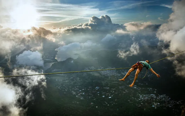 Pedra da Gavea highline, 850 meters above the city, 100 meters direct exposure, March 24, 2013. Brian Mosbaugh on the line. Carefully tiptoeing almost 3000 metres above Rio de Janeiro on a thin wire got a bit too much for this adrenaline junkie – so he decided to have a LIE DOWN. Fearless Brian Mosbaugh is so used to the perilous heights he decided he deserved a short break and proceeded to kick back and relax over the famous Brazilian city. (Photo by Scott Rogers/Caters)