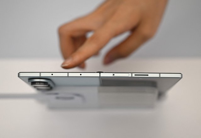 A visitor touches the Samsung Galaxy Z Fold7 smartphone at a Samsung store in Seoul on July 10, 2025. Samsung unveiled on July 9, the new generation of its foldable smartphone, the Z Fold7, dramatically slimmed down in an attempt to jumpstart this still-niche market. (Photo by Jung Yeon-je/AFP Photo)