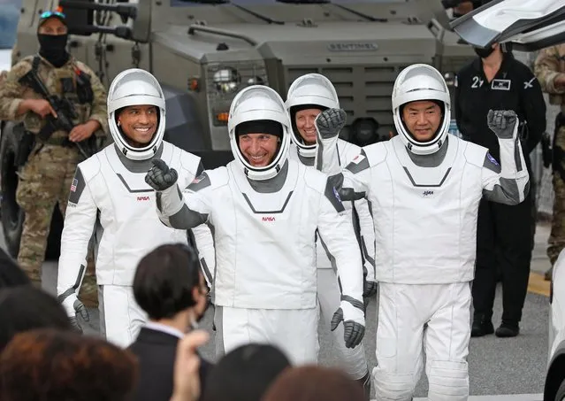 Crew-1 mission astronauts (L to R) Victor Glover, Michael Hopkins, Shannon Walker and Japanese astronaut Soichi Noguchi, walk out of the Neil A. Armstrong Operations and Checkout Building en route to launch complex 39A at the Kennedy Space Center in Florida on November 15, 2020. NASA’s SpaceX Crew-1 mission is the first crew rotation mission of the SpaceX Crew Dragon spacecraft and Falcon 9 rocket to the International Space Station as part of the agency’s Commercial Crew Program. NASA astronauts Mike Hopkins, Victor Glover, and Shannon Walker, and astronaut Soichi Noguchi of the Japan Aerospace Exploration Agency (JAXA) are scheduled to launch at 7:27 p.m. EST on November 15. (Photo by Gregg Newton/AFP Photo)