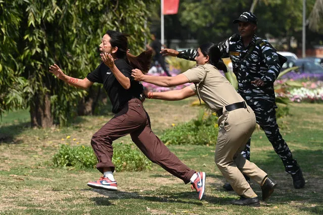Police detain a protester during a demonstration near the Chinese embassy to mark the Tibetan uprising anniversary in New Delhi on March 10, 2023. (Photo by Arun Sankar/AFP Photo)