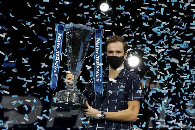 Daniil Medvedev of Russia holds up the winners trophy as confetti falls after defeating Dominic Thiem of Austria in the final of the ATP World Finals tennis match at the ATP World Finals tennis tournament at the O2 arena in London, Sunday, November 22, 2020. (Photo by Frank Augstein/AP Photo)