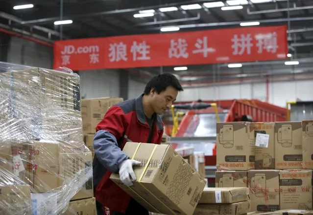 An employee works at a JD.com logistic centre in Langfang, Hebei province, November 10, 2015. (Photo by Jason Lee/Reuters)