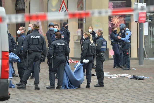 A street is blocked by the police in Trier, Germany, Tuesday, December 1, 2020. German police say people have been killed and several others injured in the southwestern German city of Trier when a car drove into a pedestrian zone. Trier police tweeted that the driver had been arrested and the vehicle impounded. (Photo by Harald Tittel/dpa via AP Photo)