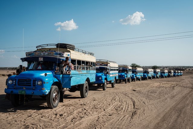 Buses that transfer Ethiopian refugee who fled the Tigray conflict from the Border Reception Centre to Um Raquba refugee camp wait to depart in convoy in Hamdayit, eastern Sudan, on December 4, 2020. Sudan – one of the world's poorest countries, now faced with the massive influx – has reopened the camp, 80 kilometres (50 miles) from the border. It once housed refugees who fled Ethiopia's 1983-85 famine that killed over a million people. (Photo by Yasuyoshi Chiba/AFP Photo)