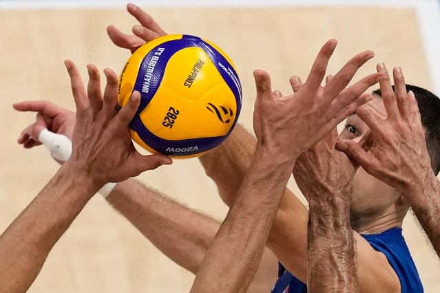 Serbia’s Pavle Perić faces the outstretched hands of Iranian players during a round-of-16 match at the Volleyball World Championship on Tuesday, September 23, 2025. (Photo by Aaron Favila/AP Photo)