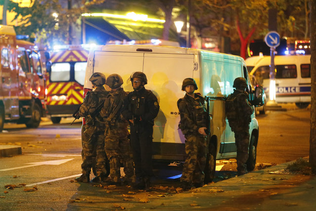 Security forces and police outside the Bataclan concert hall in central Paris as people are being held hostage on Friday, November 13, 2015. After clearing the hall of attackers, officials reportedly found more than 100 dead inside. (Photo by Olivier Corsan/Maxppp/Zuma Press/TNS)