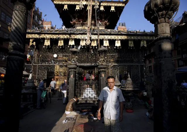 A man walks out from a temple after offering prayers in Kathmandu, Nepal October 6, 2015. (Photo by Navesh Chitrakar/Reuters)