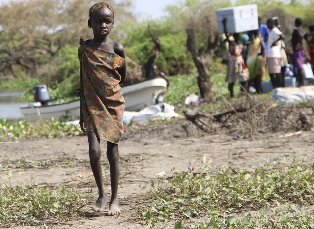 In this Wednesday December 16 2020 photo, a young girl stands near the river in Lekuangole, South Suday, South Sudan is one of four countries with areas that could slip into famine, the United Nations has warned, along with Yemen, Burkina Faso and northeastern Nigeria. (Photo by Sam Mednick/AP Photo)