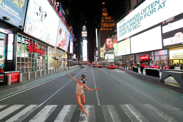 Ballet dancer and performer Ashlee Montague of New York wears a gas mask while she dances in Times Square as the coronavirus disease (COVID-19) outbreak continued in Manhattan, New York City, U.S., March 18, 2020. (Photo by Andrew Kelly/Reuters)