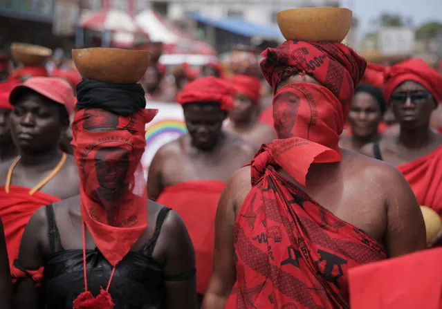 Thousands of women wearing red, a traditional color of mourning, march in protest over the death of opposition figure Etienne Yakanou, in Lome, Togo, Tuesday, May 21, 2013. Yakanou died in detention less than two weeks earlier, while being held in connection with a blaze at two huge markets in Togo's capital. Authorities say he suffered from malaria. His supporters, though, say he did not receive adequate medical care and should have been brought sooner to a hospital. (Photo by Erick Kaglan/AP Photo)