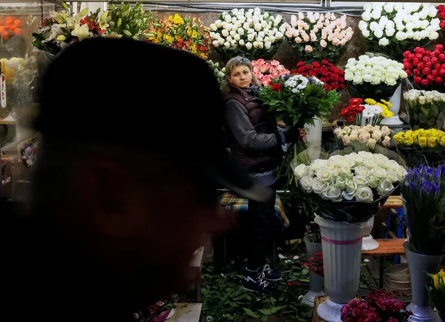A woman waits for customers as she sells flowers at an underground walkway in Kiev, Ukraine October 25, 2016. (Photo by Gleb Garanich/Reuters)