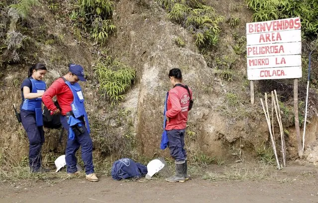 Natalia Arango (R), Aleida Toro (C) and Lina Maria Delgado prepare to ascend a hill in a landmine zone near Sonson in Antioquia province, November 19, 2015. Women's work takes on a nontraditional meaning for fifteen Colombian women who work to rid the Antioquia Mountains of deadly landmines as the country edges closer to a peace agreement with Marxist rebels to end over a decade of conflict which has claimed 220,000 lives. (Photo by Fredy Builes/Reuters)