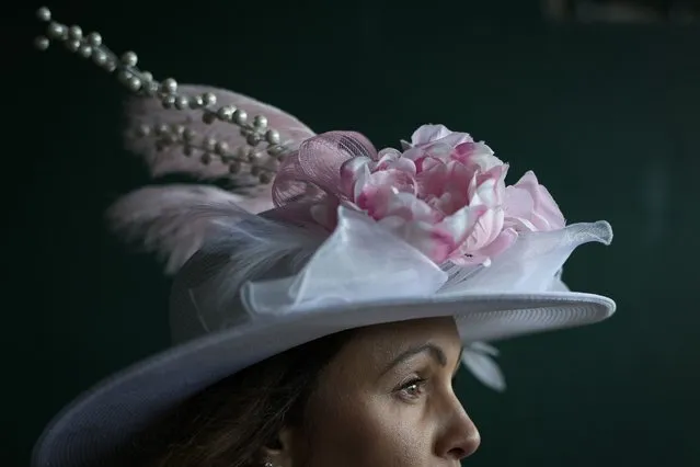 A woman walks to her seat on the day of the 149th running of the Kentucky Derby at Churchill Downs Saturday, May 6, 2023, in Louisville, Ky. (Photo by Bryan Woolston/AP Photo)