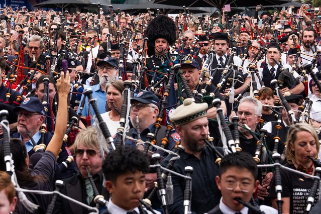 Bagpipers perform at Federation Square on November 12, 2025 in Melbourne, Australia. More than 350 pipers performed AC/DC's “It's a long way to the top (if you wanna rock 'n roll)” live, breaking the world record for largest ever bagpipe ensemble, previously set by 333 pipers in Sofia, Bulgaria in 2012. (Photo by Asanka Ratnayake/Getty Images)