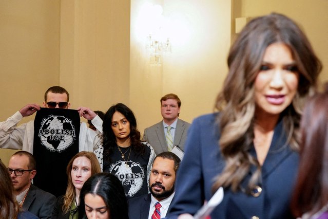 Protesters wear “Abolish ICE” T-shirts, as U.S. Homeland Security Secretary Kristi Noem attends a House Homeland Security hearing entitled “Worldwide Threats to the Homeland”, on Capitol Hill in Washington, on December 11, 2025. (Photo by Elizabeth Frantz/Reuters)